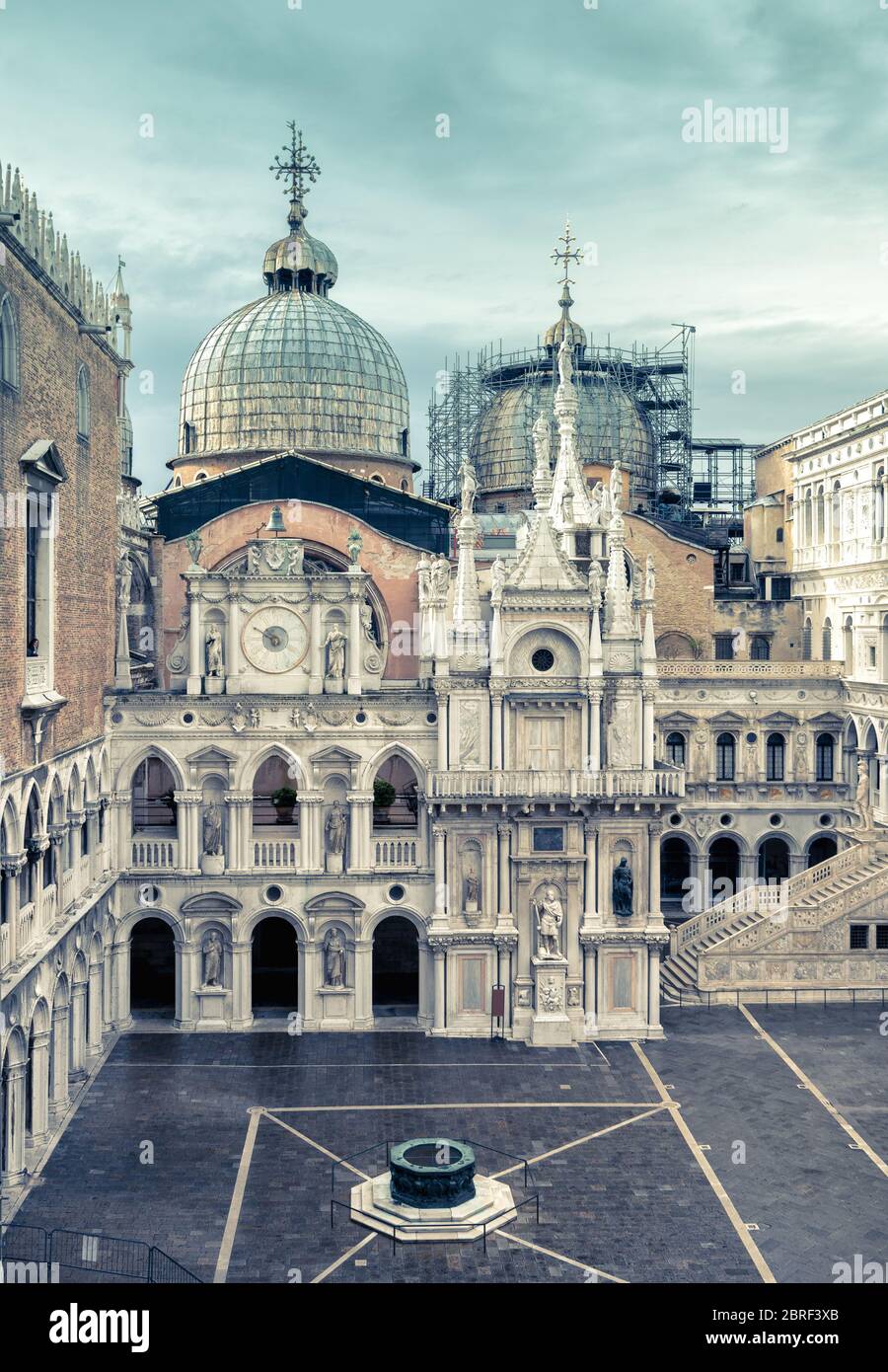 Courtyard of Doge`s Palace, or Palazzo Ducale, in Venice, Italy. Doge`s Palace is one of the main tourist destination in Venice. Domes of Saint Mark`s Stock Photo
